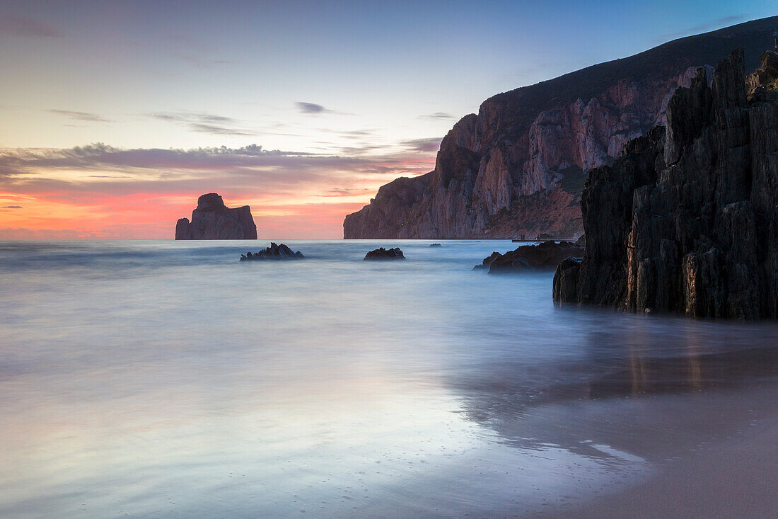 Sunset at Masua beach, in front of the Pan di Zucchero reef, Masua, Sulcis-iglesiente, Iglesias, Sardinia, Italy