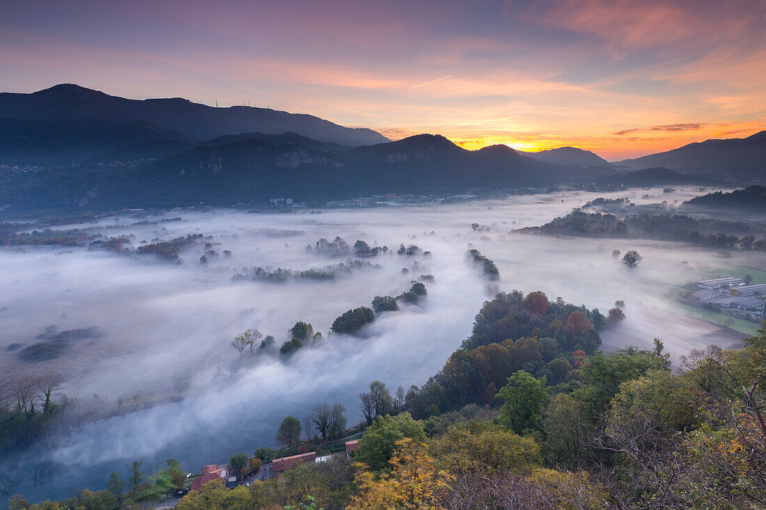 Mist over Adda river seen from Airuno at the Santuario Madonna della Rocchetta, Airuno, Parco dell'Adda Nord, Lecco province, Brianza, Lombardy, Italy