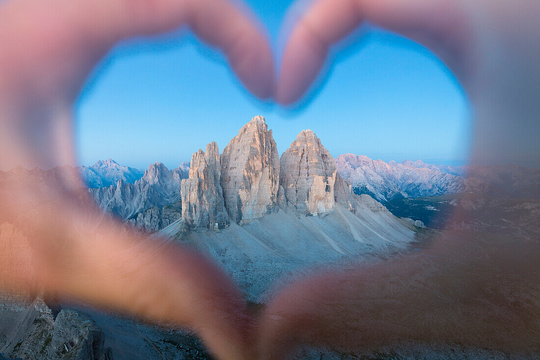hands forming an heart framing the Tre Cime di Lavaredo, Sexten Dolomites, South Tyrol, Bolzano, Italy