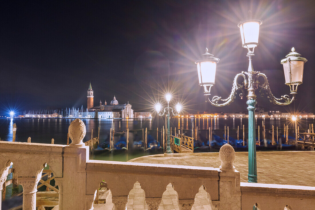 Gondolas dock, lamp post and San Giorgio Maggiore Church, Venice, Veneto, Italy
