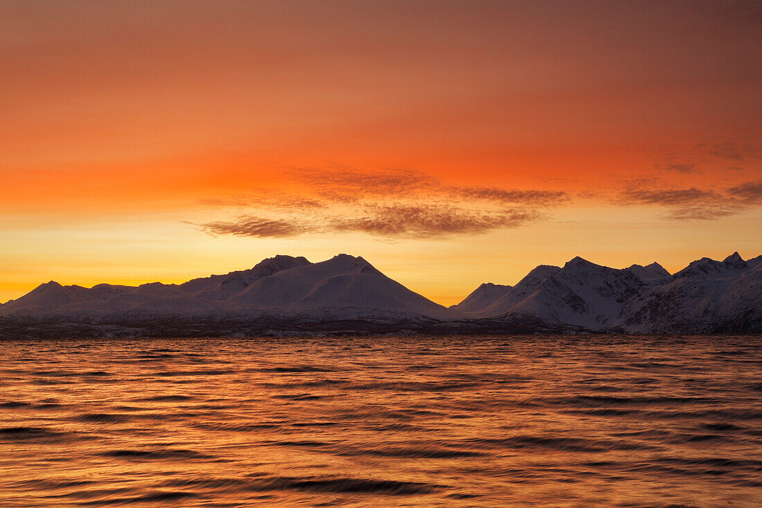 The colors of the sunset reflected in the fjord, Nordmannvik, Kafjord, Lyngen Alps, Troms, Norway, Lapland, Europe