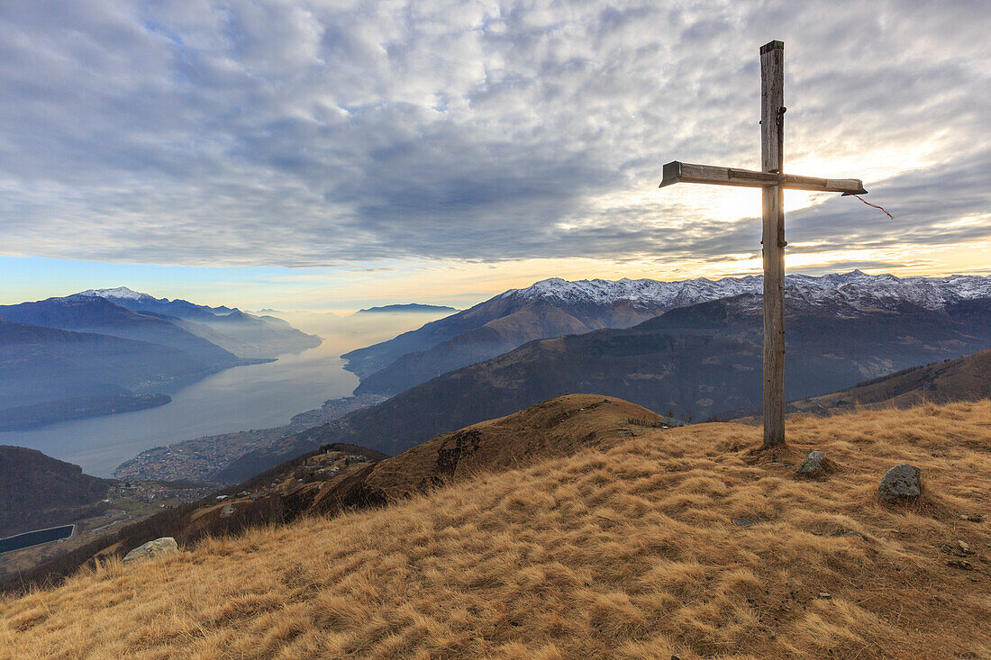 The Bodone cross at sunset, in the background Como lake, Lombardy, Italy, provence of Como