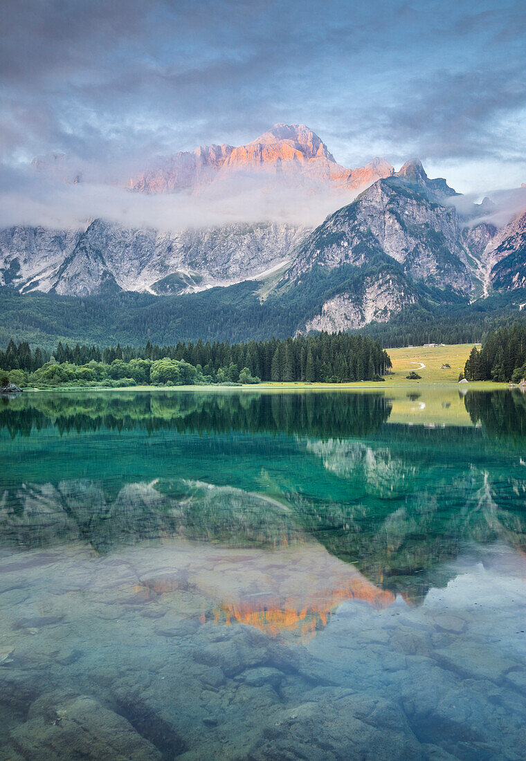 Superior Fusine Lake with Mount Mangart on the background. Fusine Lakes Natural Park, Tarvisio, Udine province, Friuli Venezia Giulia, Italy.