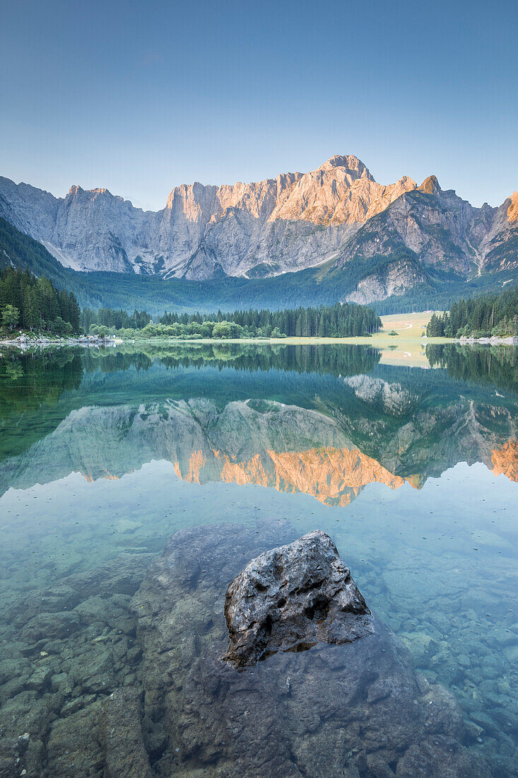 Superior Fusine Lake with Mount Mangart on the background. Fusine Lakes Natural Park, Tarvisio, Udine province, Friuli Venezia Giulia, Italy.