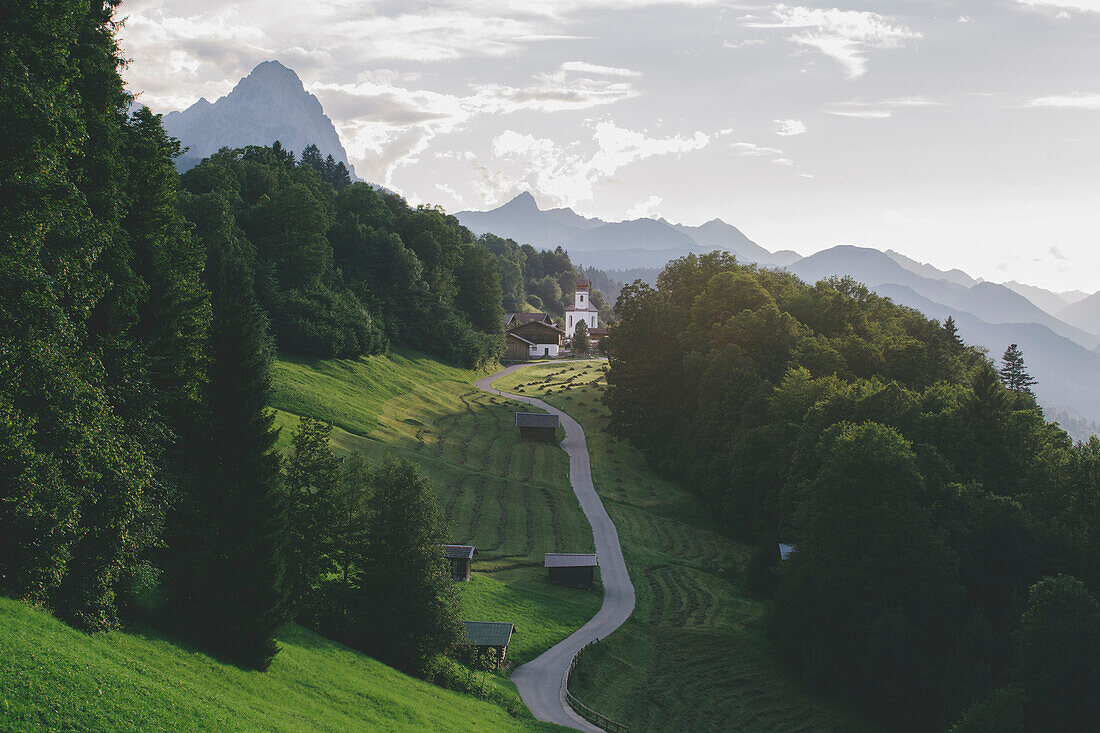 The iconic Wamberg Church, with Mount Alpspitze and Zugspitze on the background, Wamberg, Garmisch Partenkirchen, Bayern, Germany