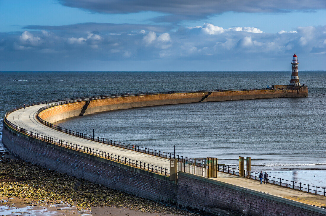 A curved pier leading out to Roker pier lighthouse; Sunderland, Tyne and Wear, England