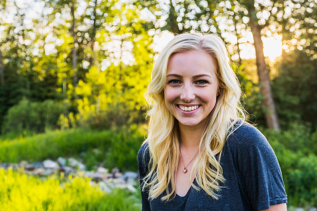 Porträt einer jungen Frau mit langen blonden Haaren in einem Park im Herbst; Edmonton, Alberta, Kanada