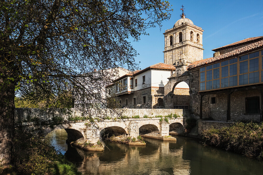 Puente del Portazgo, Puerta del Portazgo with 14th century Colegiata de San Miguel in background; Aguilar de Campoo, Palencia; Spain