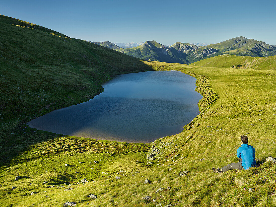 a wanderer, Lake Friesenhals, Nockberge National Park, Carinthia, Austria The