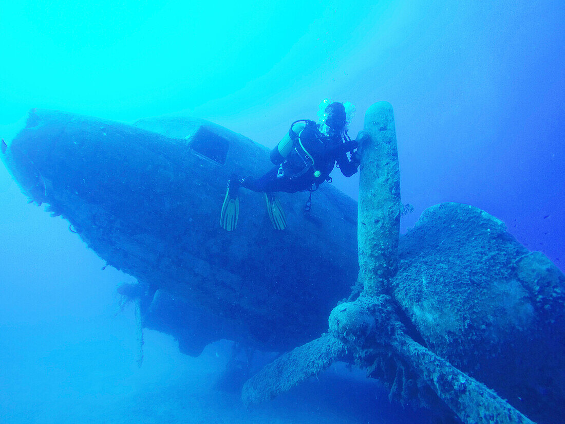 Scuba diver swimming near underwater airplane wreck, Akdeniz, Mersin Province, Turkey