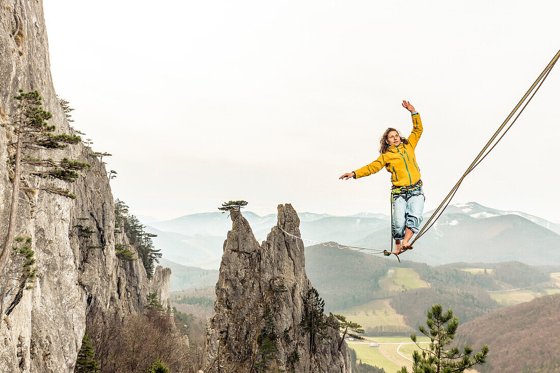 Highline athlete walking on slackline in mountains, Peilstein, Austria