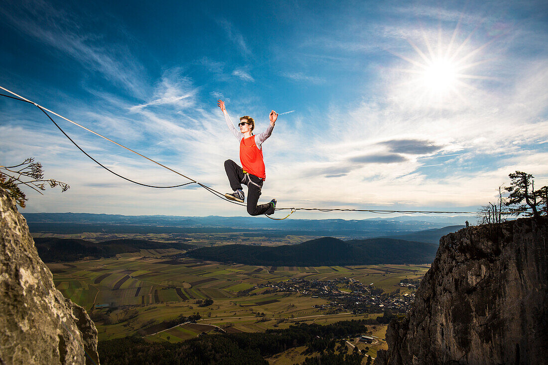 Highline athlete walking on slackline in Austrian Lower Alps, Peilstein, Austria