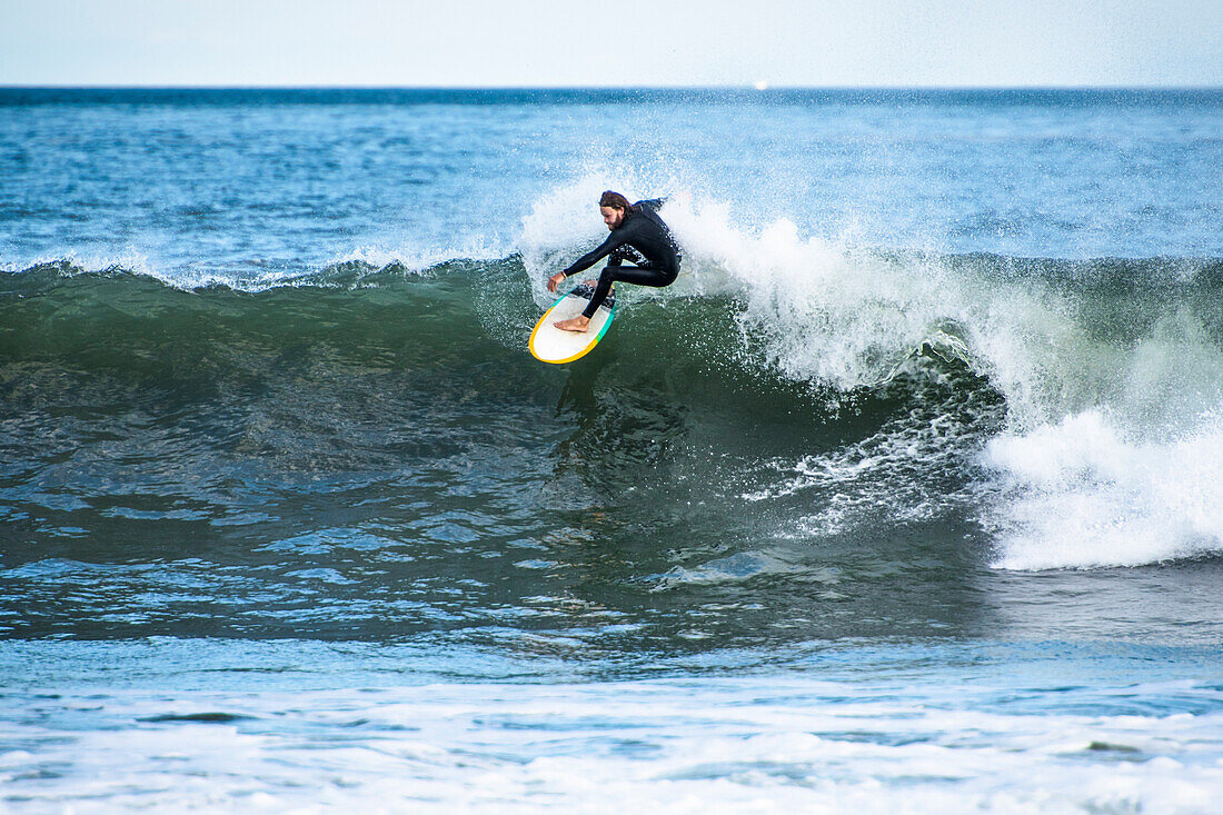Man surfing hurricane surf from Hurricane Irma, Point Judith, Narragansett, Rhode Island, USA