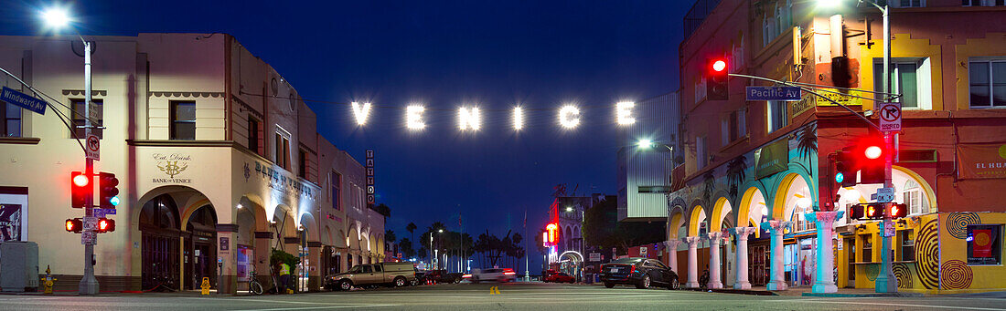 Panorama of famous Venice Beach sign lit up at night, Los Angeles, California, USA