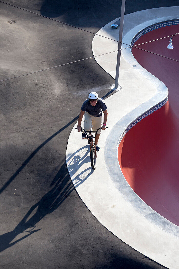 Man riding BMX bicycle in skate park, Canggu, Bali, Indonesia
