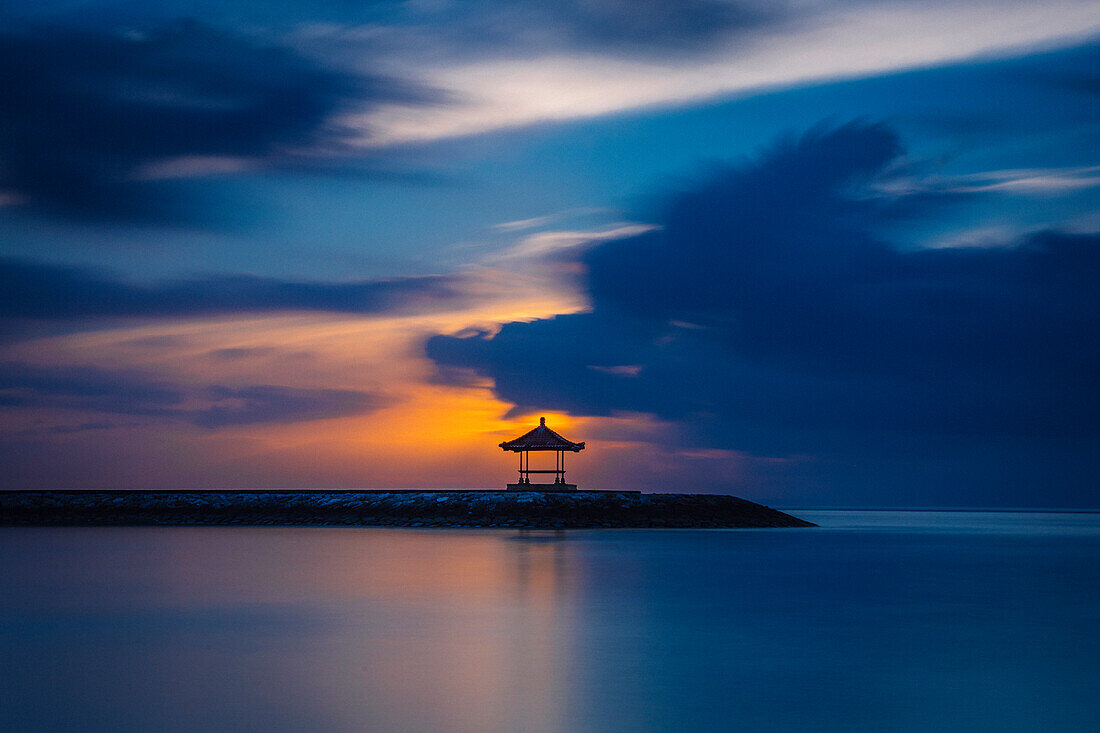 Sunset over sea and pavilion, Denpasar, Bali, Indonesia