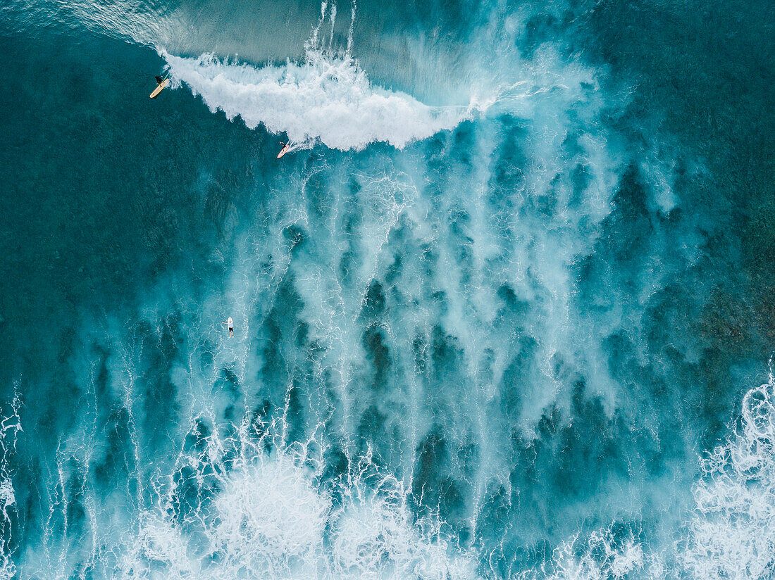 Aerial view of surfers on big wave in sea, Tenerife, Canary Islands, Spain