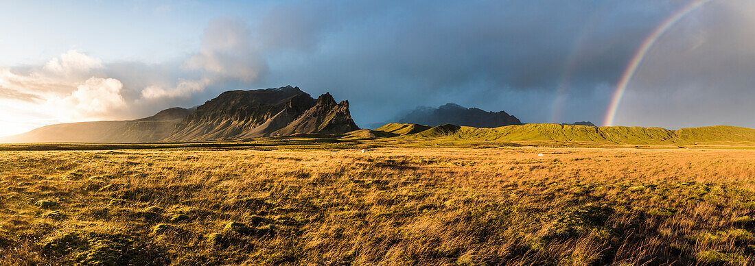 Iceland, Europe. Dramatic weather in Iceland. Sunbeams, rainbow and storm at the same moment.