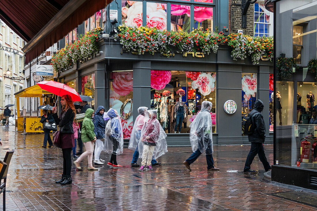 People with Umbrellas on Carnaby Street, Soho,  London