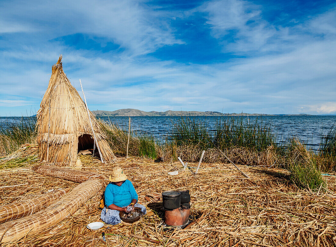 Native Uro Lady cooking, Uros Floating Islands, Lake Titicaca, Puno Region, Peru, South America