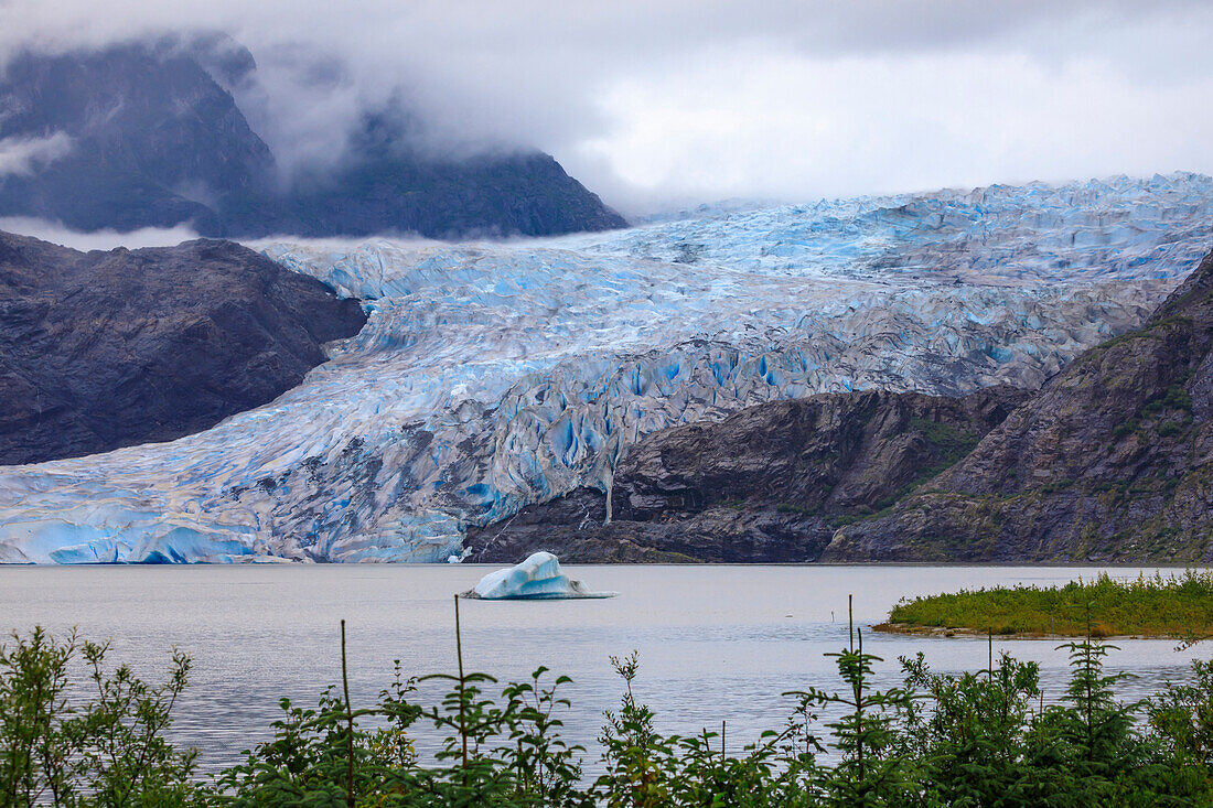 Mendenhall Glacier and Lake, with iceberg, bright blue ice, forest and mist, from Visitor Centre, Juneau, Alaska, United States of America, North America