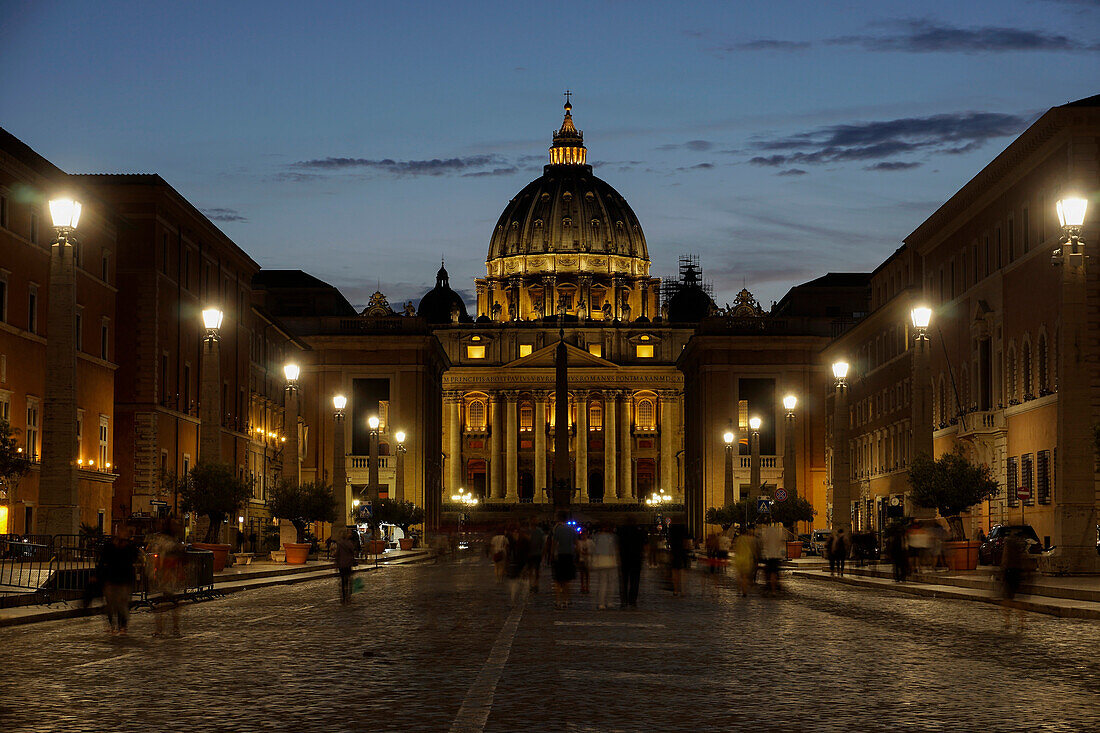 St. Peter's Cathedral night view with passing crowd, from Via della Conciliazione, Rome, Lazio, Italy, Europe