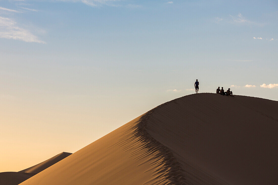 People in silhouette on Khongor sand dunes in Gobi Gurvan Saikhan National Park, Sevrei district, South Gobi province, Mongolia, Central Asia, Asia