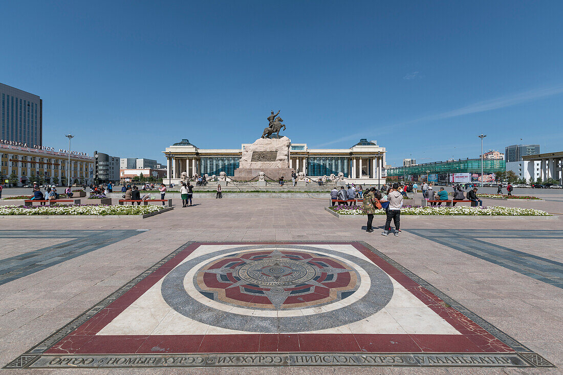 Tourists in Sukhbaatar square with Damdin Sukhbaatar statue, Ulan Bator, Mongolia, Central Asia, Asia