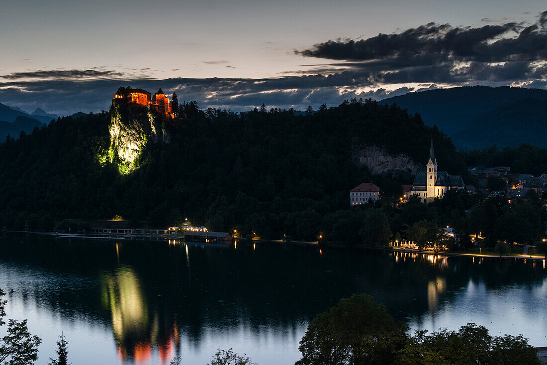 Bled Castle and St. Martin's Church at dusk, Lake Bled, Slovenia, Europe