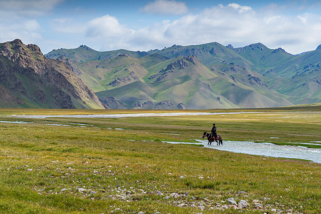 Horseman riding in Kurumduk valley, Naryn province, Kyrgyzstan, Central Asia, Asia