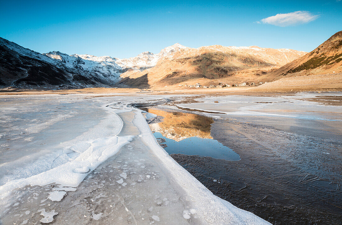 Frozen lake Montespluga at dawn, Chiavenna Valley, Sondrio province, Valtellina, Lombardy, Italy, Europe