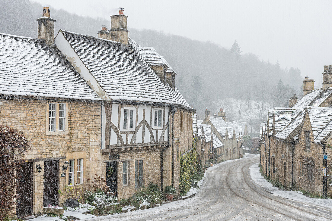 Looking down the quintessential English village of Castle Combe in the snow, Wiltshire, England, United Kingdom, Europe