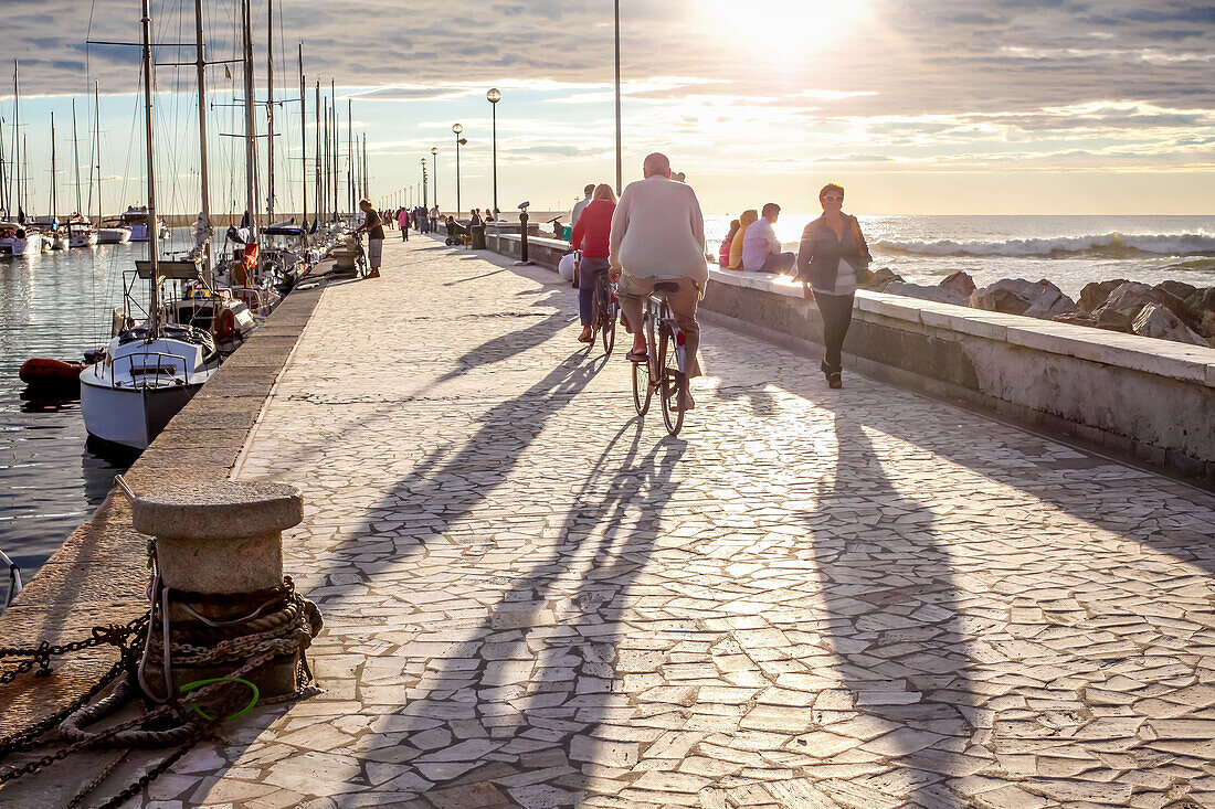 Tourists on the Pier in Viareggio at the Sunset, Viareggio, Tuscany, Italy, Europe