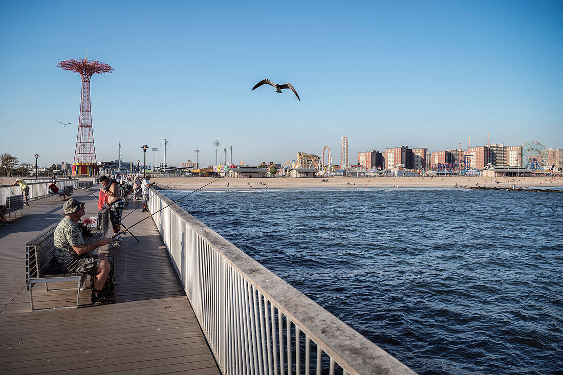 fisherman on Steeplechase Pier on Coney Island beach, Brooklyn, NYC, New York City, United States of America, USA, North America