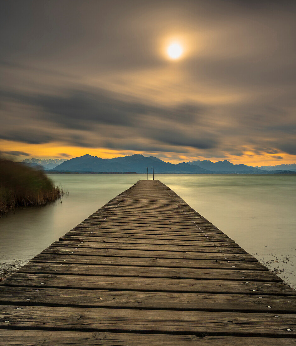 Autumn storm on Lake Chiemsee with view over the jetty to the Chiemgau Alps and Kaisergebirge, Chieming, Upper Bavaria, Germany