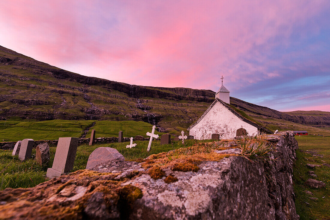 Pink sunset on church and cemetery, Saksun, Streymoy Island, Faroe Islands, Denmark, Europe