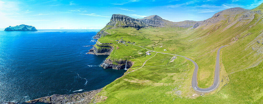 Panoramic of the road in between meadows and ocean, Gasadalur, Vagar Island, Faroe Islands, Denmark, Europe