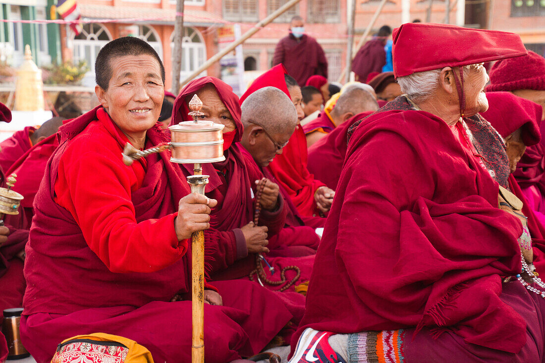 Tibetan Buddhist nun and prayer wheel, Boudhanath Stupa, Kathmandu, Nepal, Asia
