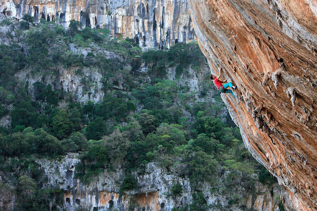 A climber scales cliffs at Kyparissi, southern Greece, Europe