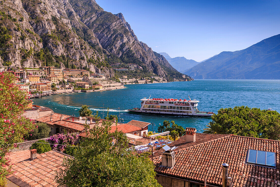 Elevated view of ferry on Lake Garda and rooftops in the port of Limone, Lake Garda, Lombardy, Italian Lakes, Italy, Europe