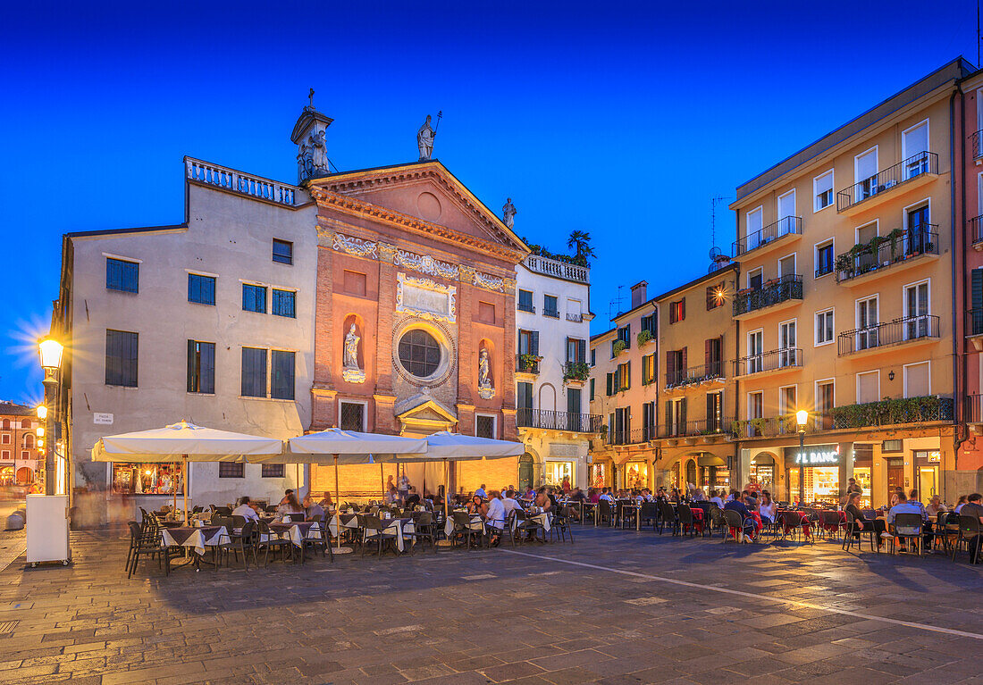 View of cafes and Chiesa di San Clemente in Piazza dei Signori at dusk, Padua, Veneto, Italy, Europe