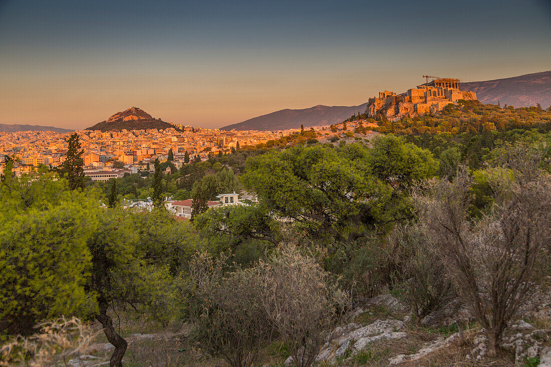 View of The Acropolis and Likavitos Hill at sunset from Filopappou Hill, Athens, Greece, Europe