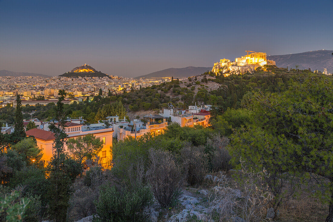 View of The Acropolis and Likavitos Hill at dusk from Filopappou Hill, Athens, Greece, Europe