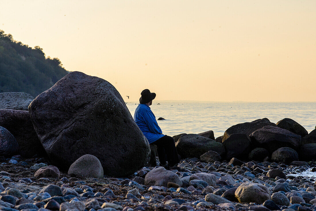 Man with hat at the cliff Großkluetzhoeved at Boltenhagen, Ostseekueste, Mecklenburg-Vorpommern, Germany