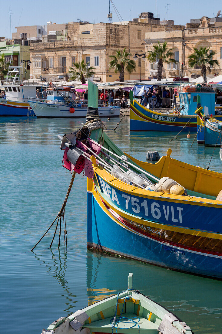 Traditional brightly painted fishing boats in the harbour at Marsaxlokk, Malta, Mediterranean, Europe