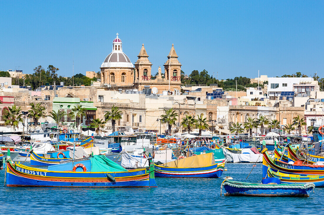 Traditional brightly painted fishing boats in the harbour at Marsaxlokk, Malta, Mediterranean, Europe