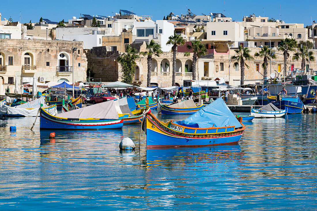 Traditional brightly painted fishing boats in the harbour at Marsaxlokk, Malta, Mediterranean, Europe