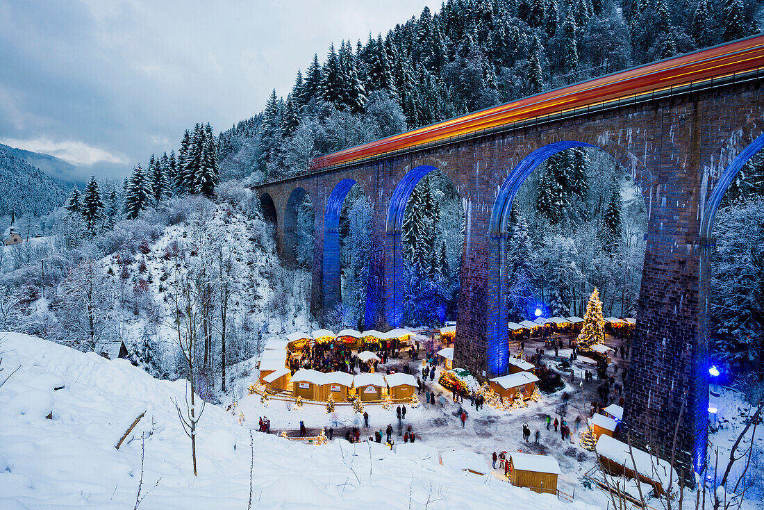 Snowy Christmas market under a railway viaduct, illuminated, Ravennaschlucht, Höllental near Freiburg im Breisgau, Black Forest, Baden-Württemberg, Germany