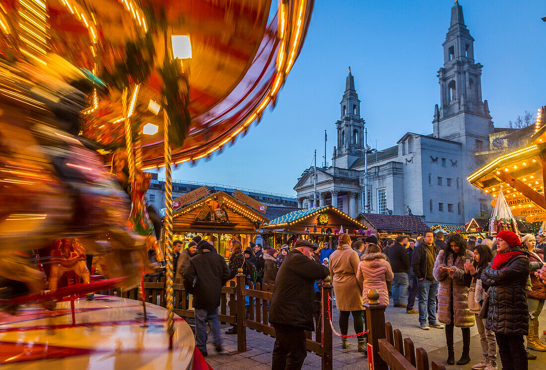 View of carousel and Christmas Market stalls at Christmas Market, Millennium Square, Leeds, Yorkshire, England, United Kingdom, Europe