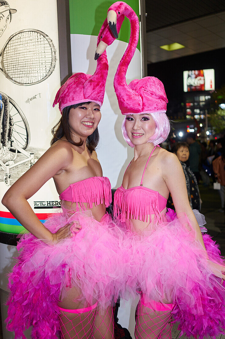 Japanese girls dressed as flamingos at the Halloween celebrations in Shibuya, Tokyo, Japan, Asia